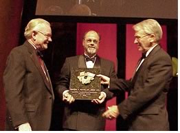 AAF Chair Harold L. Adams, FAIA (left) congratulates Charleston Mayor Joseph P. Riley, Hon. AIA, recipient of the Keystone Award, as plaque-bearer Reuben Musgrave looks on.