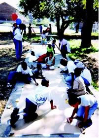 Neighborhood children draw their ideas on a poster.