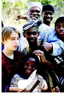 Master storyteller 'Baba C' surrounded by local youth.