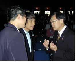 Ando (center) and interpreter speak with AIA President Gordon H. Chong, FAIA.