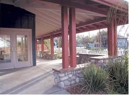 A wide porch and overhang provide a shaded area for residents to chat with neighbors or wait for transportation. The jury particularly appreciated the varying height of bench walls, which provide a diversity of seating options.  Photo by Erick Mitiken, AIA.