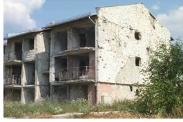 Rough concrete frames are all that remain of most homes in Bosnia, the author reports.