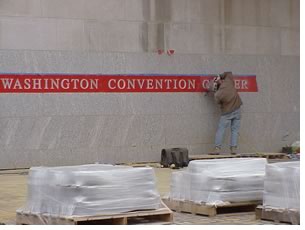 Workers put the final touches on the outside of the New Washington Convention Center, prior to its grand opening weekend at the end of March. Photo by Tracy F. Ostroff.