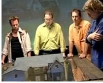 Todd Erlandson, AIA, (right) contemplates a model home that he will help turn into tropical oasis. He, along with host Steve Watson, (left), Craig Rizzo, illustrator, and Peter Hampton, production designer, create this Monster House design. Photo courtesy Original Productions.