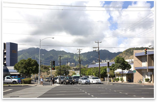 Base photo: A photo of existing conditions at the intersection of King St. (in foreground, running right-left) and University Ave. in Honolulu, looking northwest toward Manoa Valley. The buildings of the University of Hawaii are in the middle ground, the Koolau mountan range is in the background. Photograph by Duane Preble.