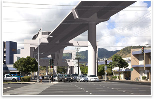 This is Photo 1 overlaid with a photo simulation of the elevated rail guideway and station proposed by the City administration for the site. The guideway is 60 feet above grade because it is designed to pass over the H-1 freeway, which is approximately 1/4 mile north of the photo location. Photo Simulation work by Berkeley, Calif.-based Urban Advantage Inc.