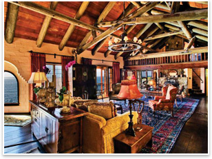 The main living room at Villa Rockledge has wood beam ceilings and floors made of mahogany boards.