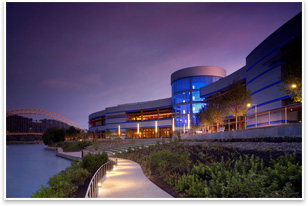 Rivers Casino is located in Pittsburgh's North Shore along the Ohio River. The design features an undulating front faade that curves with the contour of the waters edge. Exterior aluminum panels also underscore the imagery of the river. The building opens to a park, promenade, and 1,000-seat outdoor amphitheater that steps down to the waters edge. Photo courtesy of Bergman Walls & Associates.