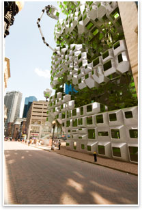 The pods attach to the building structure irregularly, creating masses and voids that could be used for algae biofuel research and development or vertical park space.