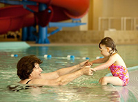 Grandmother and Granddaughter playing in swimming pool at Moldaw Family Residences at Taube Koret Campus for Jewish Life